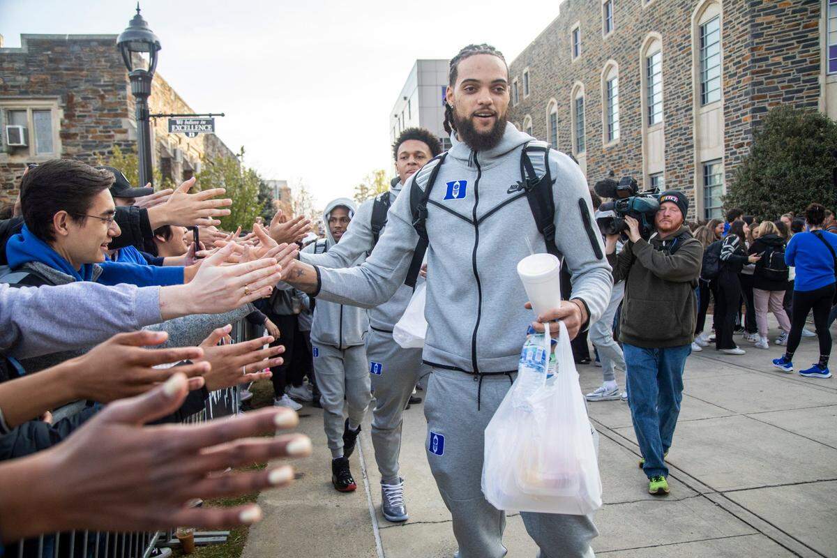From front, Duke’s Theo John, Paolo Banchero and Jeremy Roach prepare to depart for the Final Four in New Orleans Tuesday, March 29, 2022 outside Cameron Indoor Stadium.