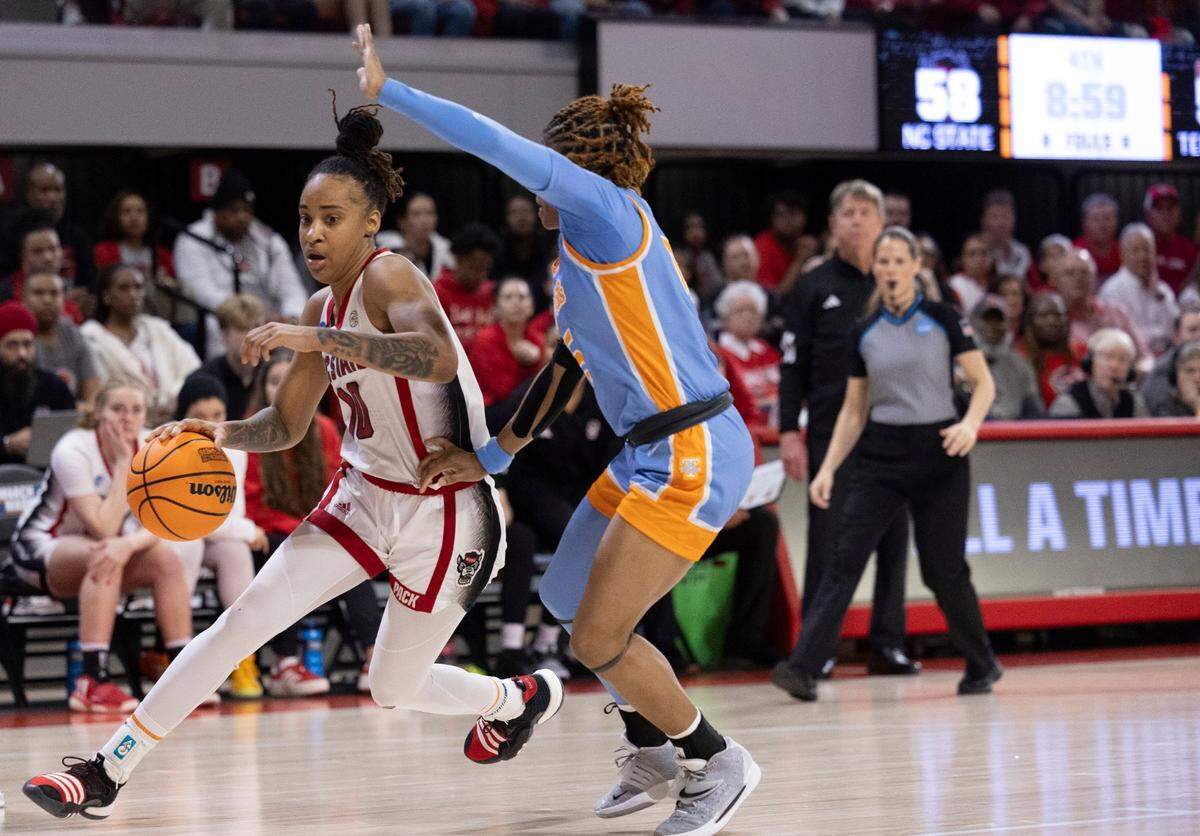NC State’s Aziaha James (10) maneuvers around Tennessee’s Jasmine Powell (15) during the second half of the second round of the Division I Women’s Basketball Championship at Reynolds Coliseum in Raleigh, on March 25, 2024. The Wolfpack won 79-72.
