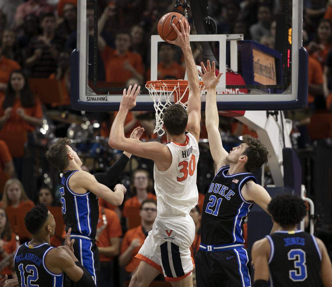Virginia’s Jay Huff (30) dunks over Duke’s Matthew Hurt (21) during the first half on Saturday, February 29, 2020 at John Paul Jones Arena in Charlottesville, Va.