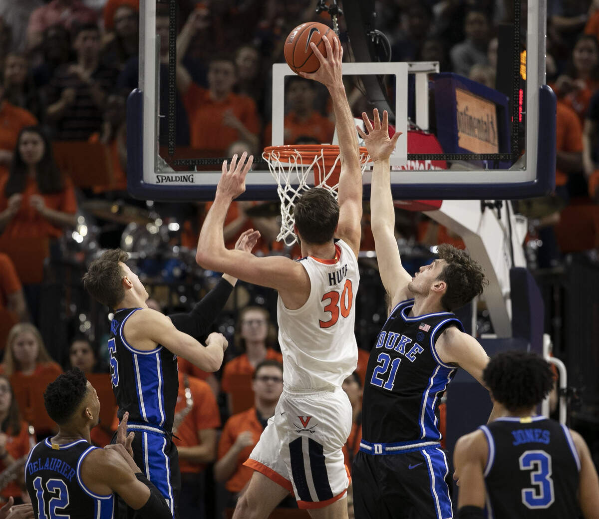 Virginia’s Jay Huff (30) dunks over Duke’s Matthew Hurt (21) during the first half on Saturday, February 29, 2020 at John Paul Jones Arena in Charlottesville, Va.