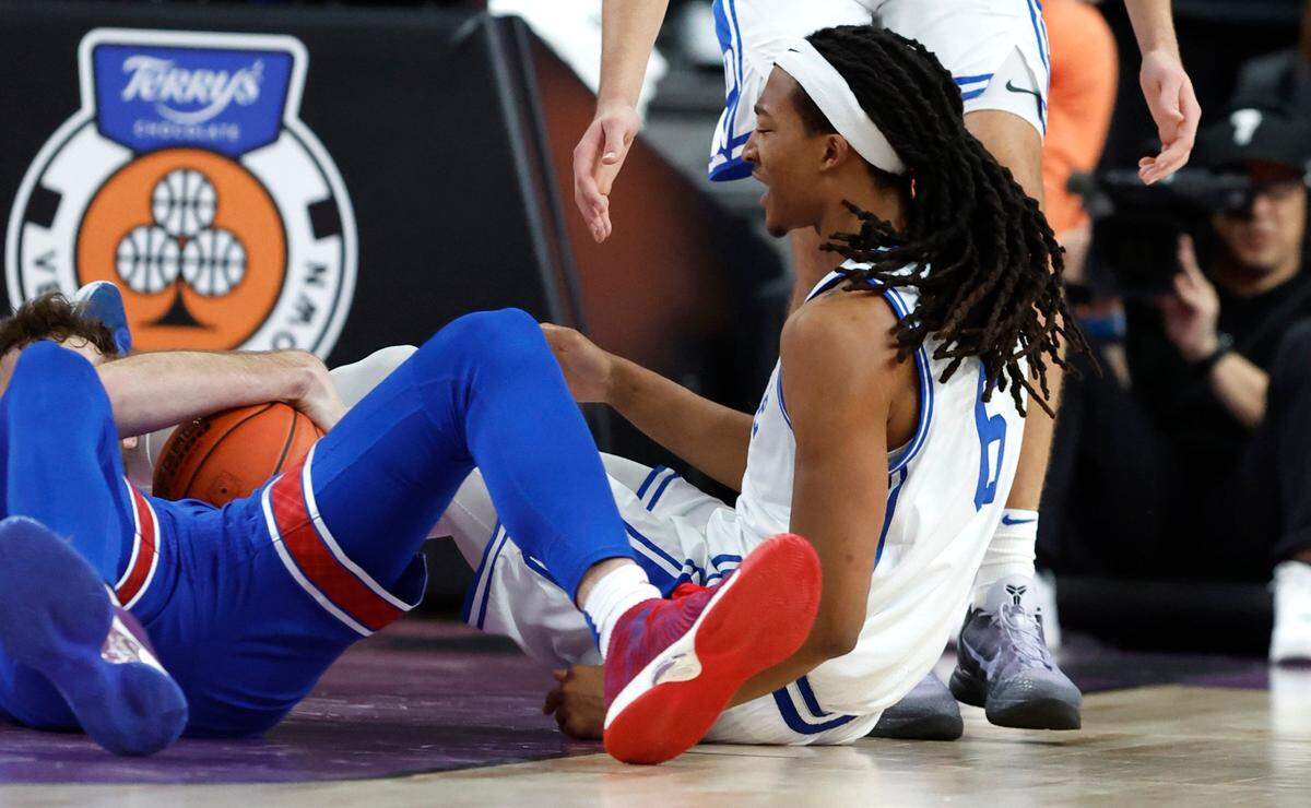 Duke’s Maliq Brown (6) reacts after he kicked by Kansas’ Hunter Dickinson (1) during the second half of Kansas’ 75-72 victory over Duke in the Vegas Showdown at T-Mobile Arena in Las Vegas, Nev., Tuesday, Nov. 26, 2024.