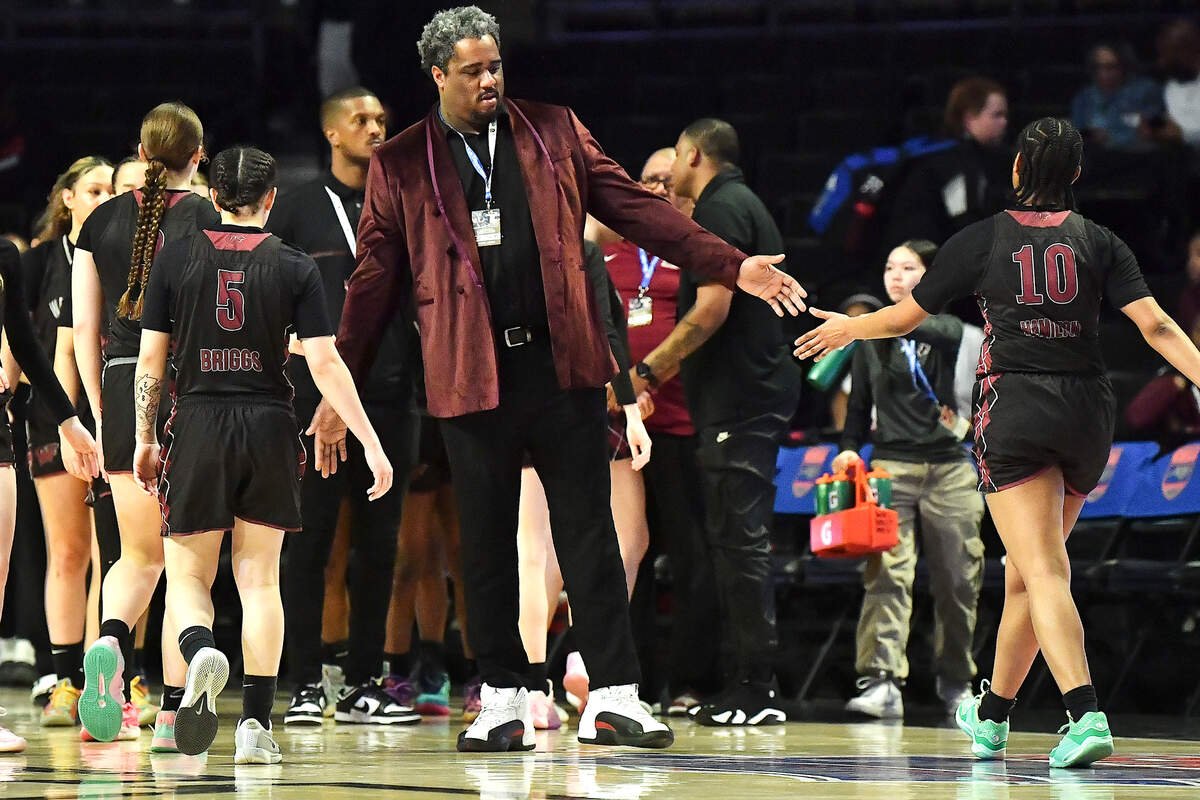 Wakefield head coach Jason Lee congratulates his team at the end of the first half against Hoggard. The Wakefield Wolverines and the Hoggard Vikings met in the NCHSAA 4A East Regional Final in Winston-Salem, N.C. on March 12, 2025.