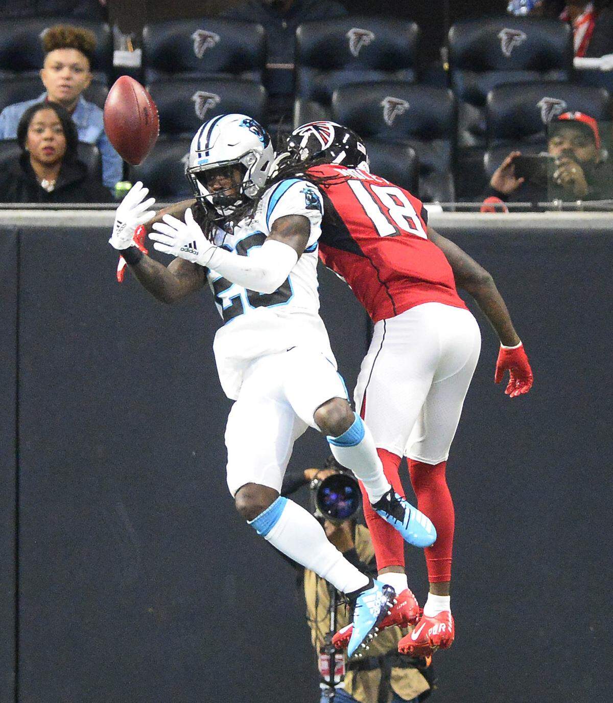 Panthers cornerback Donte Jackson (26) breaks up a pass intended for Atlanta wide receiver Calvin Ridley (18) in the first half at Mercedes-Benz Stadium in Atlanta Sunday. The Falcons won, 40-20.