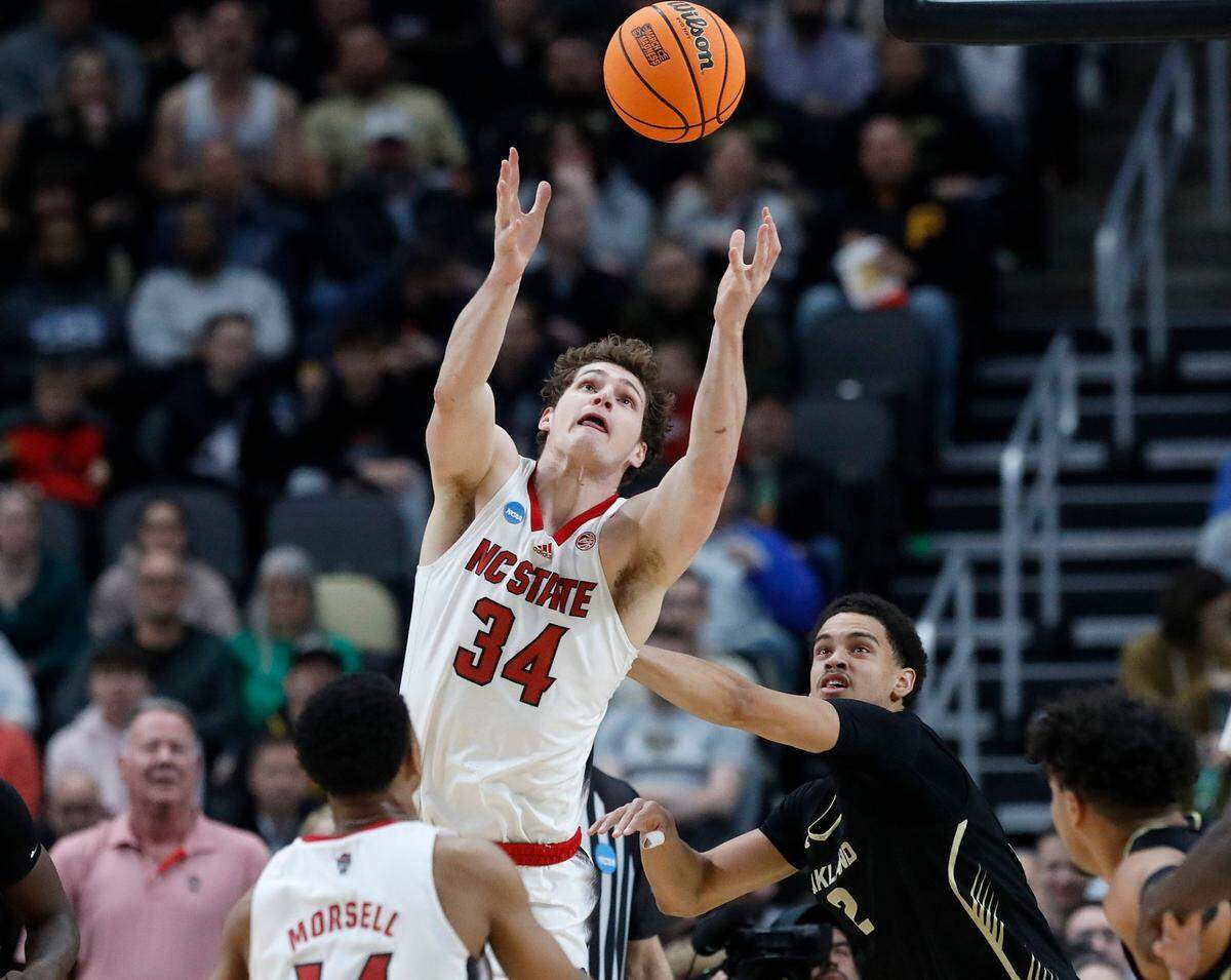 N.C. State’s Ben Middlebrooks grabs a rebound over Oakland’s Chris Conway during the first half of the Wolfpack’s NCAA Tournament second round game on Saturday, March 23, 2024, at PPG Paints Arena in Pittsburgh, Pa.