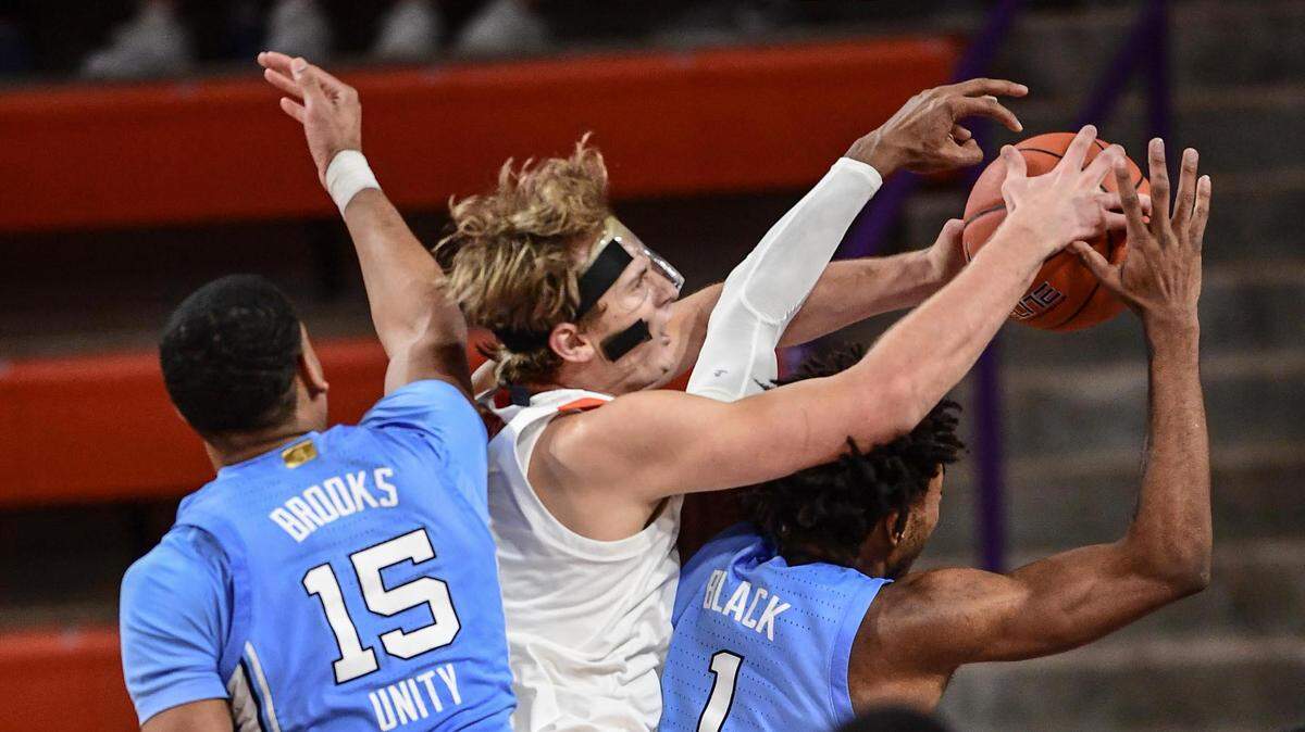 Clemson junior forward Hunter Tyson(5) and North Carolina guard Leaky Black(1) reach for a ball during the second half Feb 2, 2021; Clemson, South Carolina, USA; at Littlejohn Coliseum.