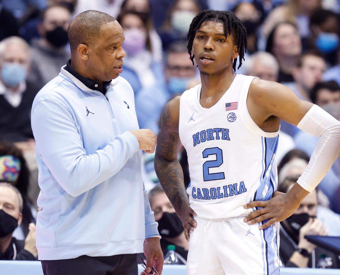 North Carolina head coach Hubert Davis talks with Caleb Love (2) during the second half of UNC’s 70-63 victory over Louisville at the Smith Center in Chapel Hill, N.C., Monday, Feb. 21, 2022.