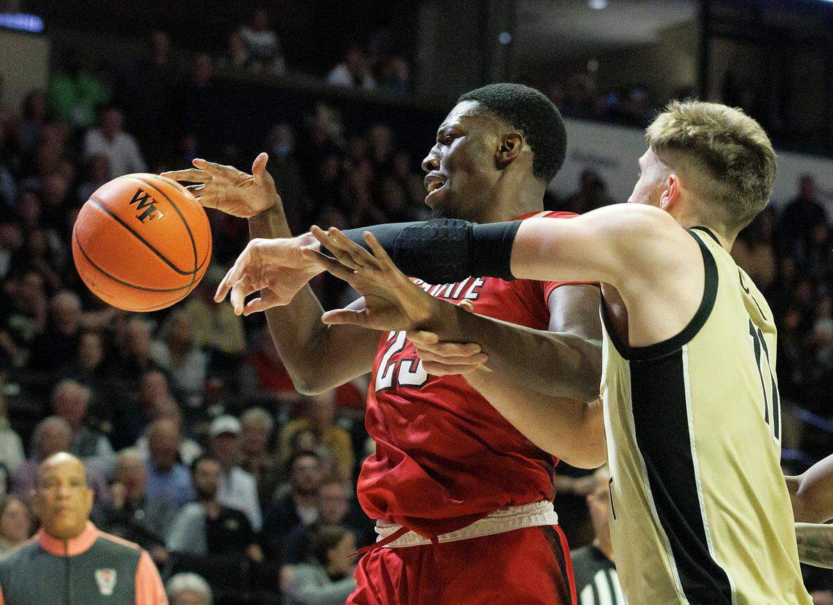 N.C. State’s Mohamed Diarra and Wake Forest’s Andrew Carr battle for possession during the second half of the Wolfpack’s 83-79 loss on Saturday, Feb. 10, 2024, at Lawrence Joel Veterans Memorial Coliseum in Winston-Salem, N.C.