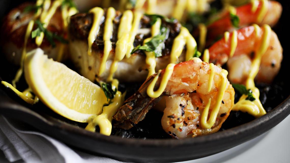 Parizade’s squid ink paella incorporates the daily catch, shrimp, scallops and saffron aioli.