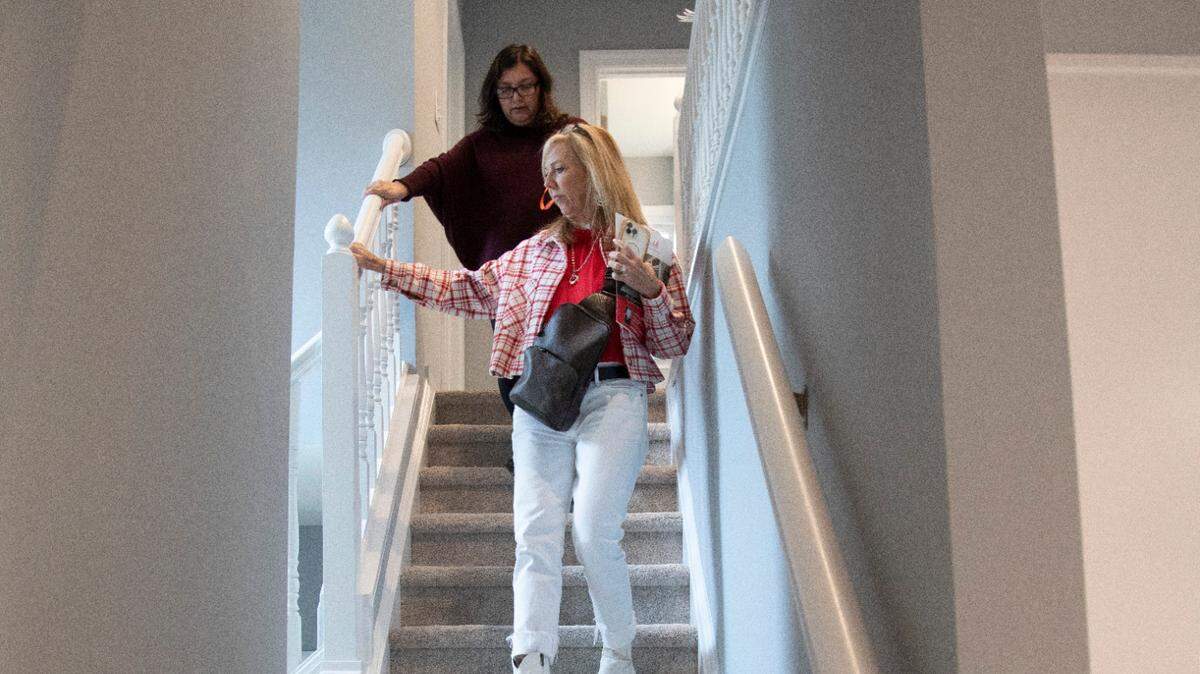 First-time home buyer Carolina Acuipil, top, and Real Estate Broker Colleen Blondell tour a home for sale in Cary on Thursday, April 27, 2023.