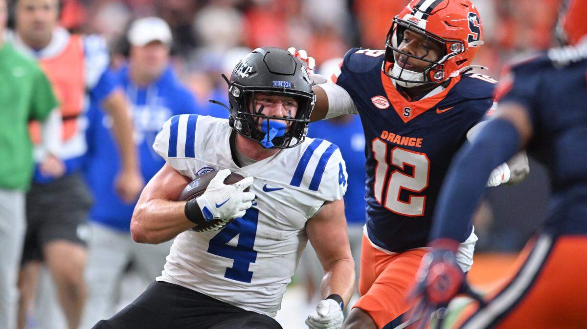 Sep 27, 2025; Syracuse, New York, USA; Duke Blue Devils running back Anderson Castle (4) prepares for contact from Syracuse Orange linebacker Anwar Sparrow (12) in the second quarter at the JMA Wireless Dome. Mandatory Credit: Mark Konezny-Imagn Images