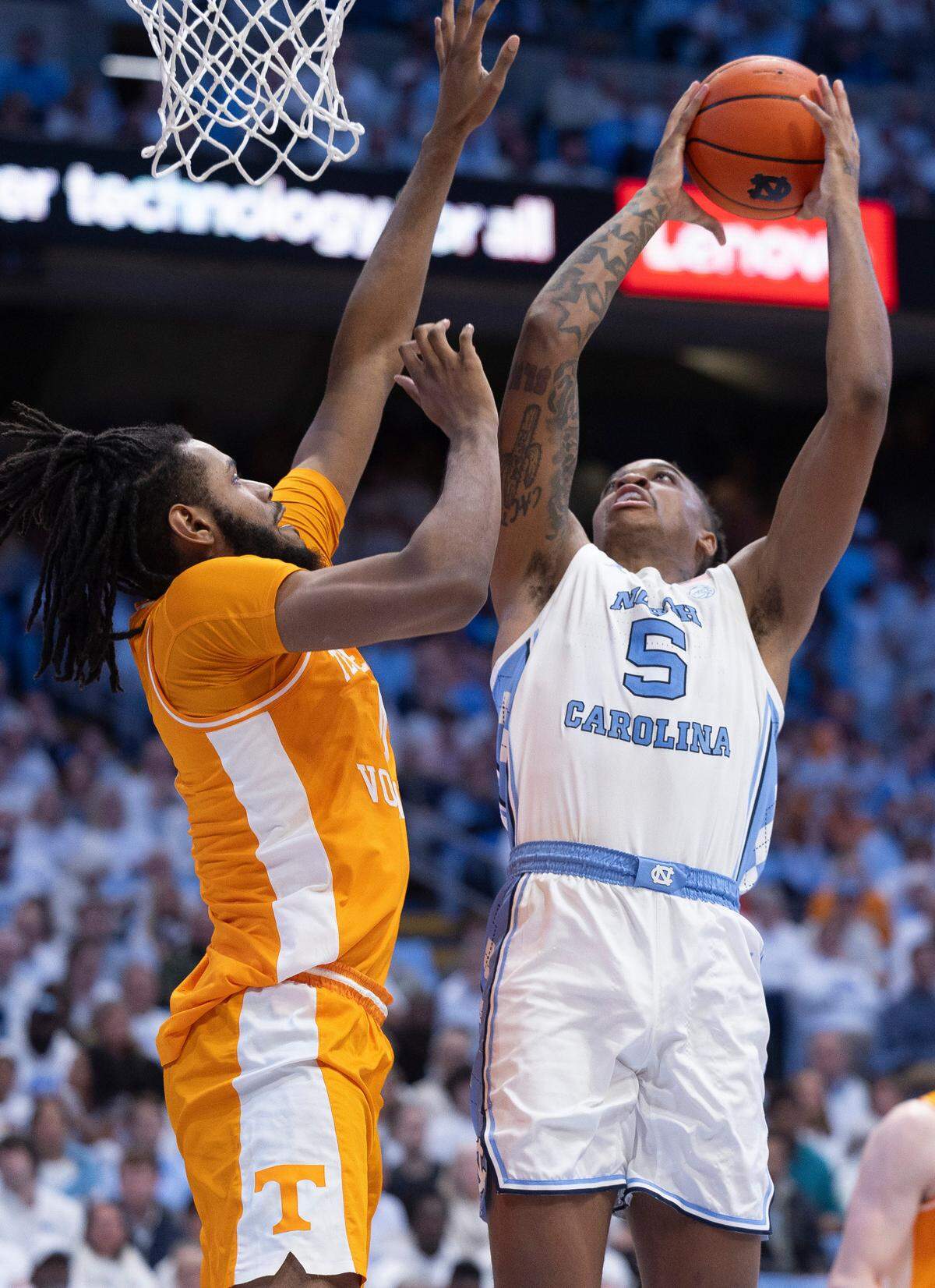 North Carolina’s Armando Bacot (5) muscles his way to the basket against Tennessee’s Jonas Aidoo (0) in the second half on Wednesday, November 29, 2023 at the Smith Center in Chapel Hill, N.C.