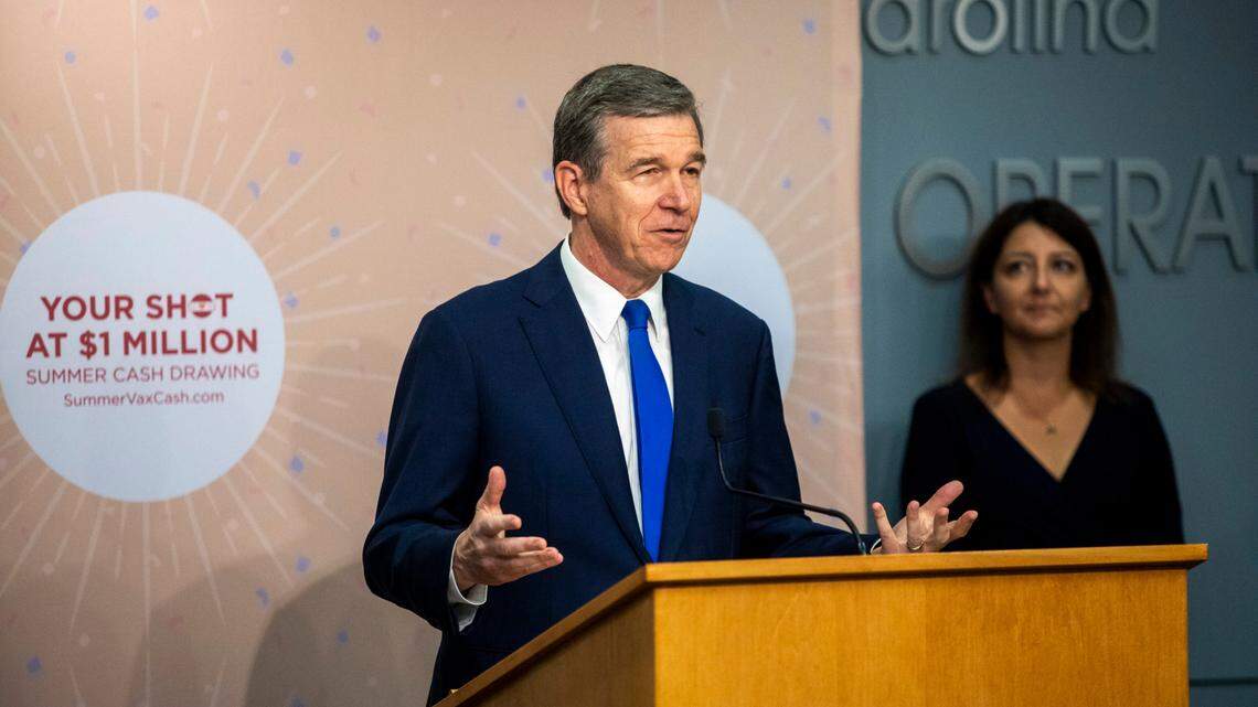 Gov. Roy Cooper speaks as Secretary of the NC Department Health and Human Services Dr. Mandy Cohen looks on after announcing the first winners of the Summer Cash Drawing and Summer Cash 4 College Drawing at the Monday, June. 28, 2021 at the NC Emergency Operations Center in Raleigh.