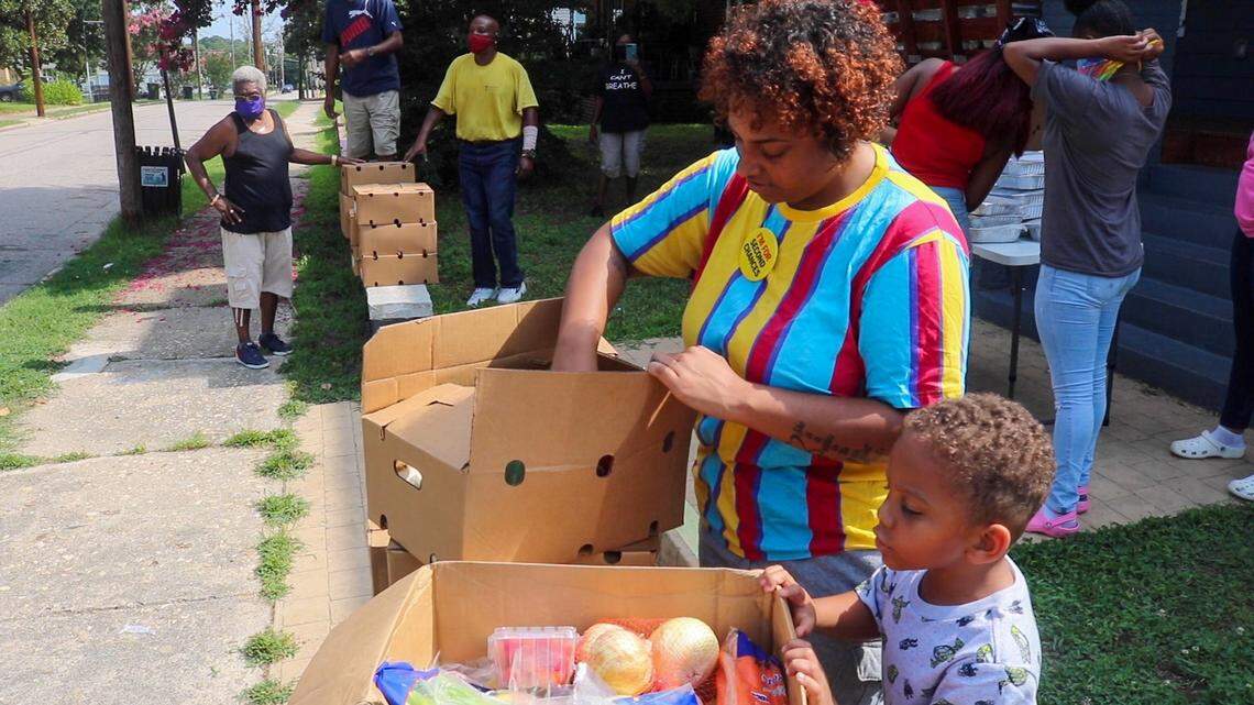 In this July 2020 photo, Tyara Morrison rearranges a box of fresh produce given away for free by NC Second Chance Alliance and Justice Served NC. The groups gave away free food in Raleigh during the pandemic.