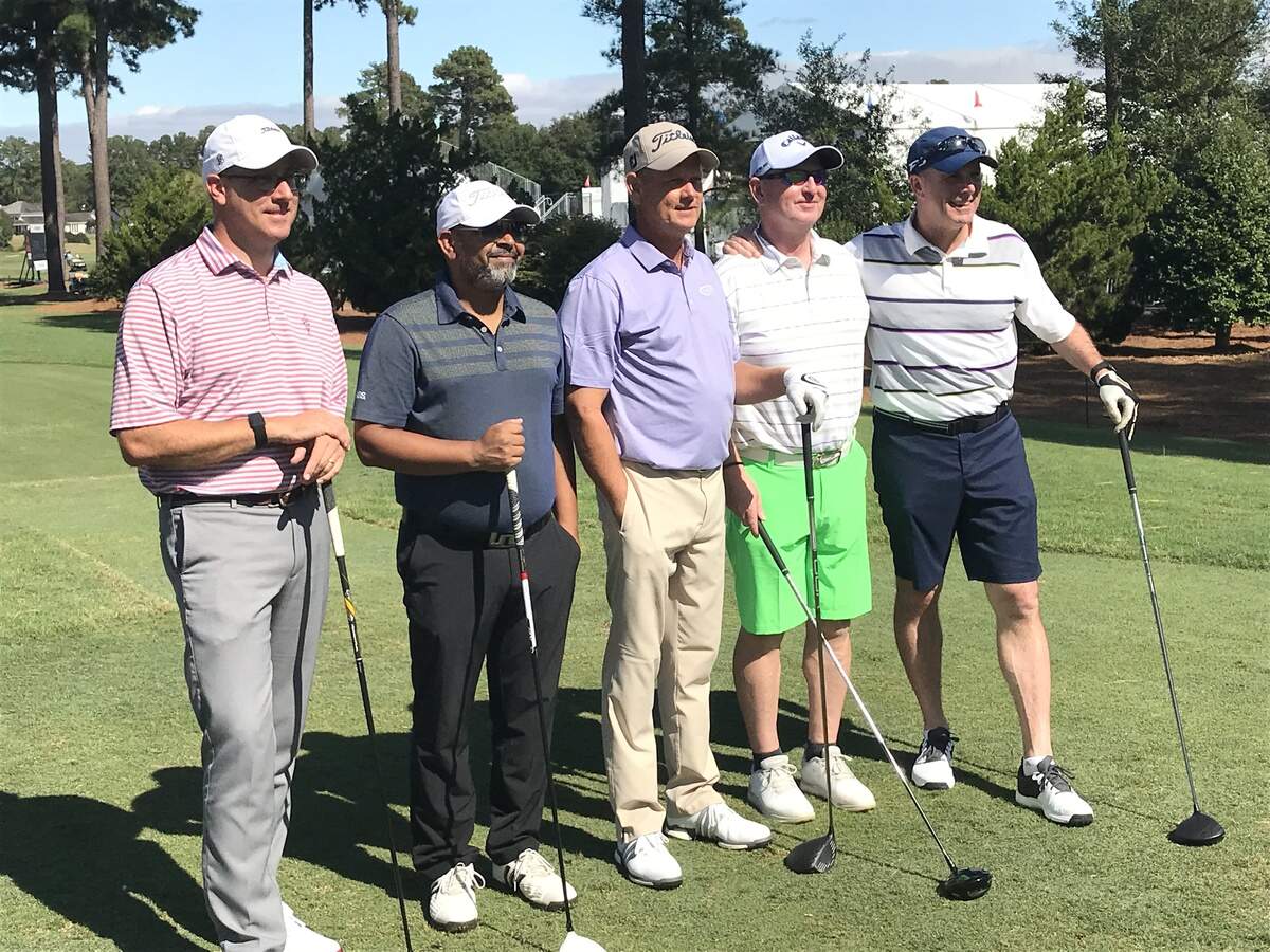 Chris Hockaday of Angier, center, takes a group photo with pro-am partners on Oct. 10, 2019 during the SAS Championship Pro-Am at Prestonwood Country Club.