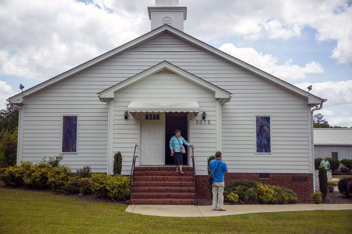 Gay Hicks, a member of the congregation at New Life Baptist Church, leaves the sanctuary after worshiping together indoors with about 20 other members and pastor Steve Grice who announced they would be defying Gov. Roy Cooper’s executive order to limit gatherings to 10 people in an effort to slow the spread of COVID-19, on Sunday, May 17, 2020, in Smithfield, N.C. Johnston County Sheriff Steve Bizzell said he would not enforce the order and Saturday a federal judge’s order allowed North Carolina religious leaders to open their doors to their congregations.