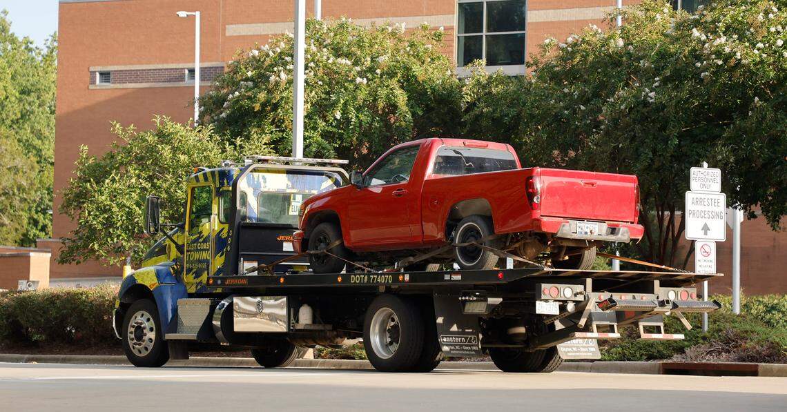 A red pickup truck is transported to the Wake County Detention Center/City-County Bureau of Identification in Raleigh, N.C., Wednesday, August 17, 2022. The truck was seized by law enforcement officials on Wednesday in Winston-Salem in the investigation of the killing of Wake County Deputy Ned Byrd, according to someone with knowledge of the investigation.