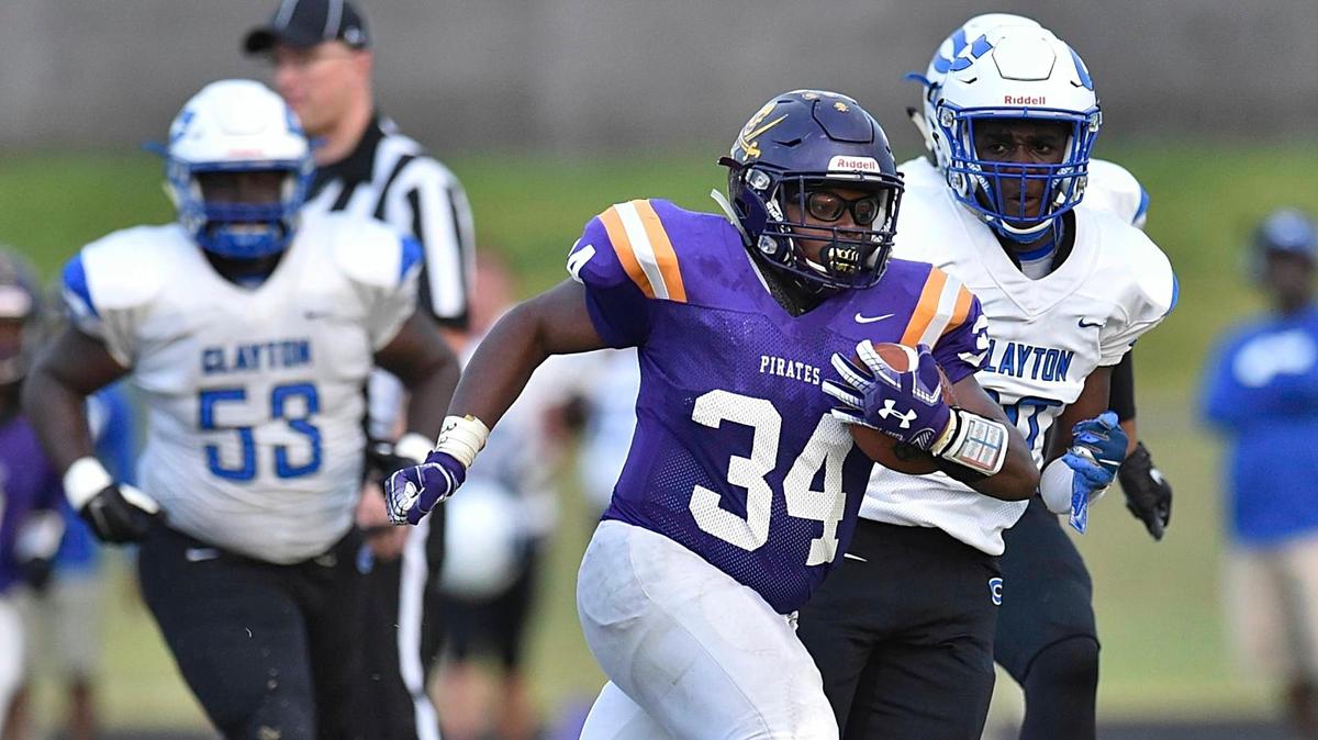 Corinth Holders’ Kambron Whitaker (34) runs for yardage during the first quarter. The Corinth Holders Pirates and the Clayton Comets met in a non-conference football game in Wendell, N.C. on September 4, 2019.