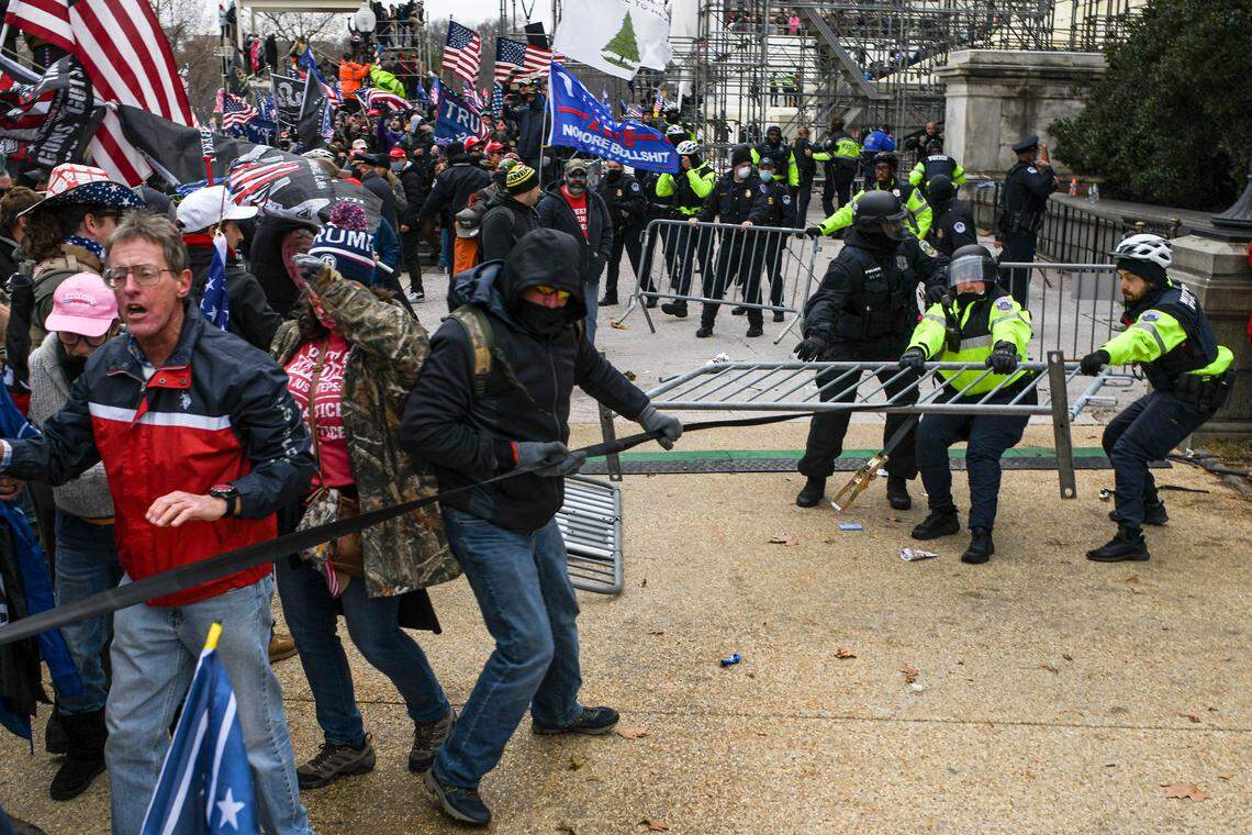 Protesters struggle with police for a security barricade at the Capitol in Washington, Wednesday, Jan 6, 2020. The Capitol building was placed on lockdown, with senators and members of the House locked inside their chambers, as Congress began debating President-elect Joe BidenÕs victory. President Trump addressed supporters near the White House before protesters marched to Capitol Hill.