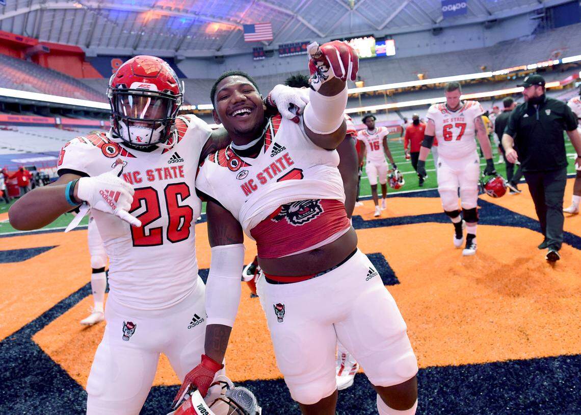 North Carolina State’s football players celebrate their win over Syracuse on Saturday, Nov. 28, 2020, at the Carrier Dome in Syracuse, N.Y.