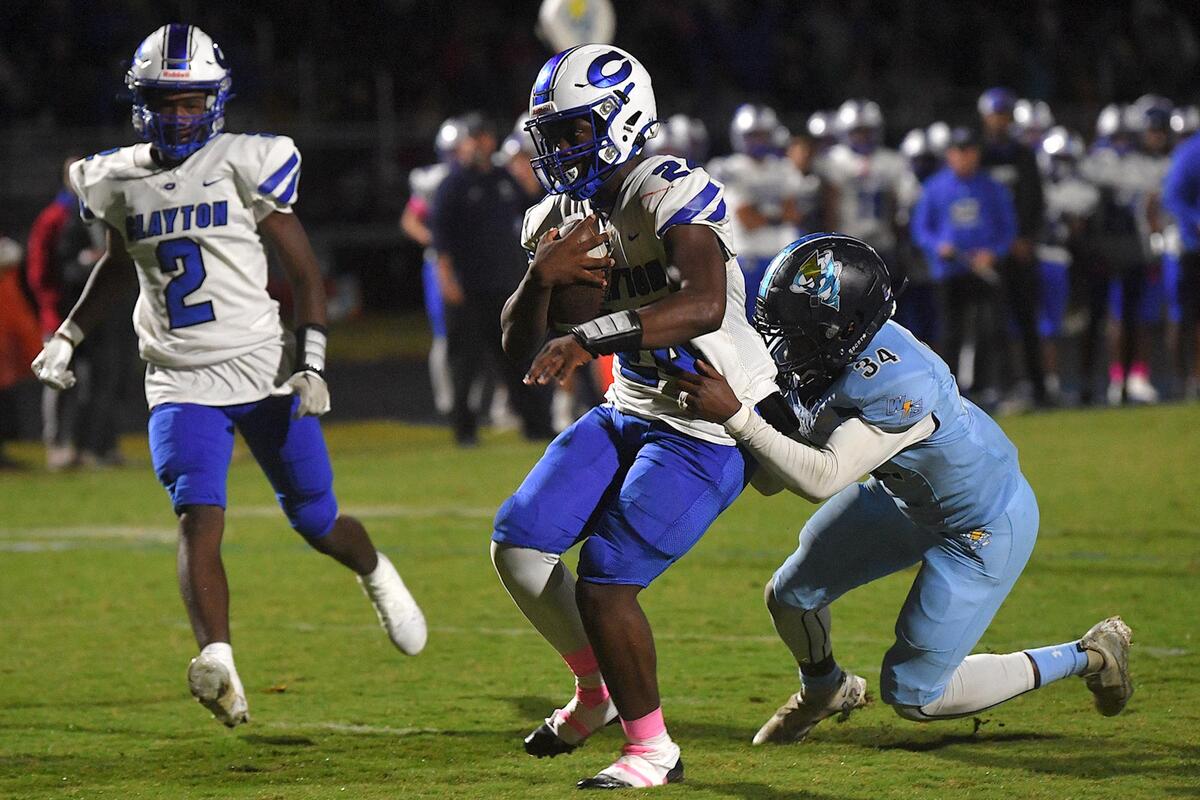 Clayton running back Ny’quavious Armston (24) scores the touchdown against Willow Spring’s Josiah Gray )34) during the first half. The Clayton Comets and the Willow Spring Storm met in a conference football game in Fuquay-Varina, N.C. on October 20, 2023.