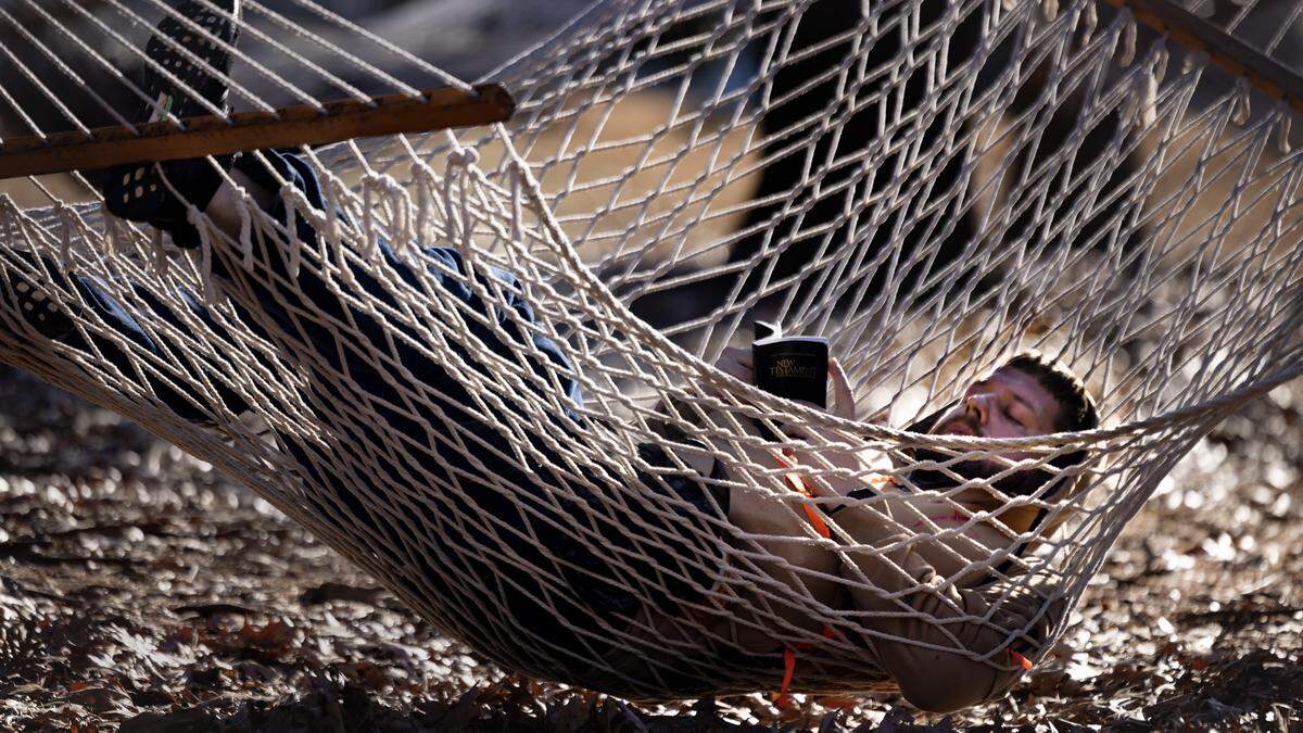 Andrew Pitschmann relaxes in one of the hammocks at Raleigh’s Dix Park as he enjoys the warm Christmas Eve weather on Dec. 24, 2025.