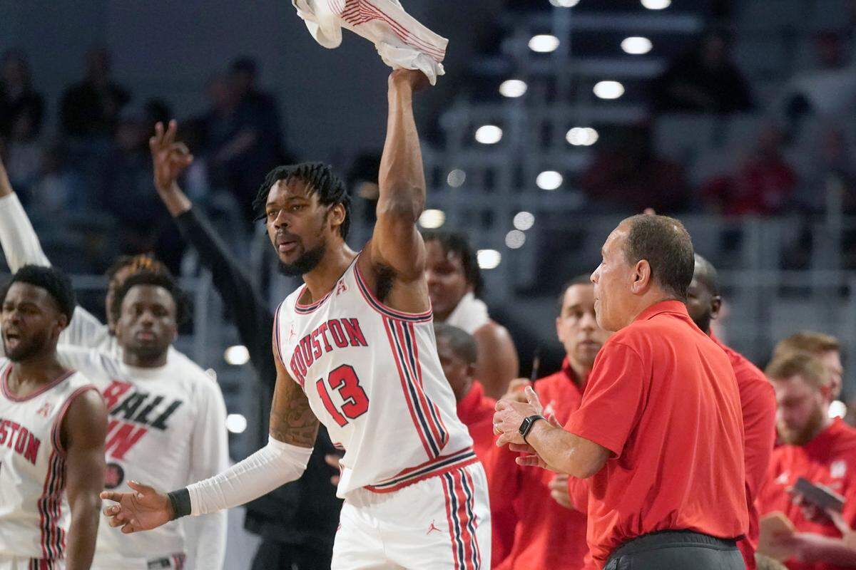 Houston forward J’Wan Roberts (13) cheers on teammates during the first half of an NCAA college basketball game against Memphis for the American Athletic Conference tournament championship in Fort Worth, Texas, Sunday, March 13, 2022.