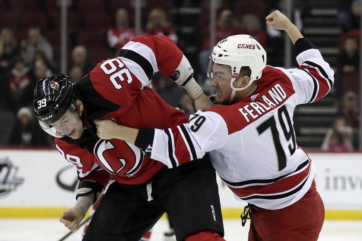 New Jersey Devils right wing Kurtis Gabriel (39) and Carolina Hurricanes left wing Micheal Ferland (79) fight during the first period of an NHL hockey game, Sunday, Feb. 10, 2019, in Newark, N.J. (AP Photo/Julio Cortez)