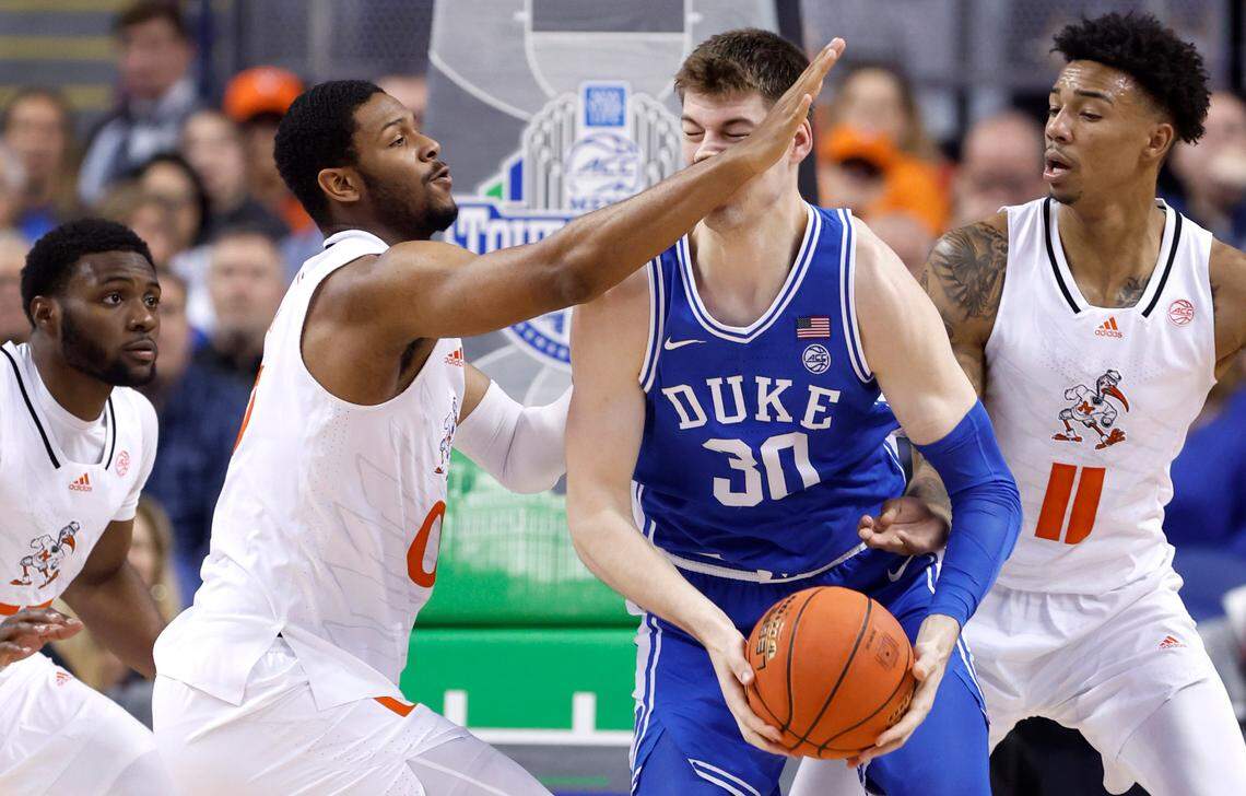 Duke’s Kyle Filipowski keeps the ball from Miami’s A.J. Casey during the first half of Duke’s game against Miami in the semifinals of the ACC Men’s Basketball Tournament in Greensboro, N.C., Friday, March 10, 2023.