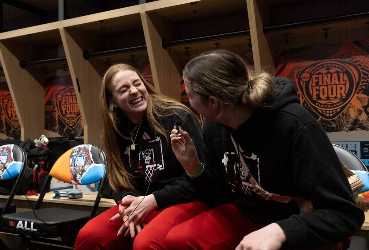 N.C. State’s Laci Steele and Lizzy Williamson laugh while answering questions from media in the locker room at Rocket Mortgage FieldHouse on Thursday, April 4, 2024, in Cleveland, Ohio. The Wolfpack will face South Carolina in the Final Four on Friday.