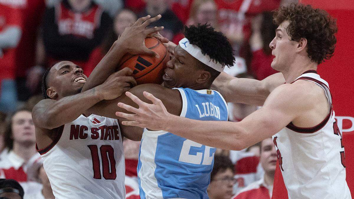 N.C. State’s Marcus Hill and Ben Middlebrooks swarm North Carolina’s Ven-Allen Lubin during the second half of the Wolfpack’s 63-61 loss on Saturday, Jan. 11, 2025, at Lenovo Center in Raleigh, N.C.