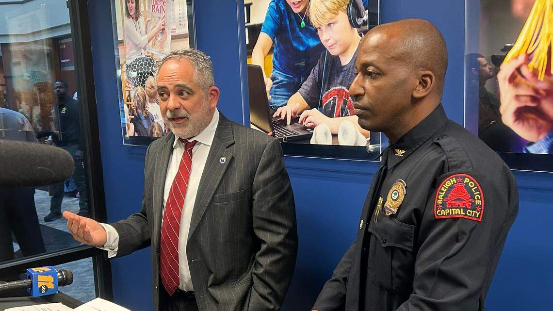 Wake County school board chair Chris Heagarty and Raleigh Deputy Police Chief Rico Boyce speak at a news conference about a gun safety storage resolution in Cary, N.C., on March 19, 2024