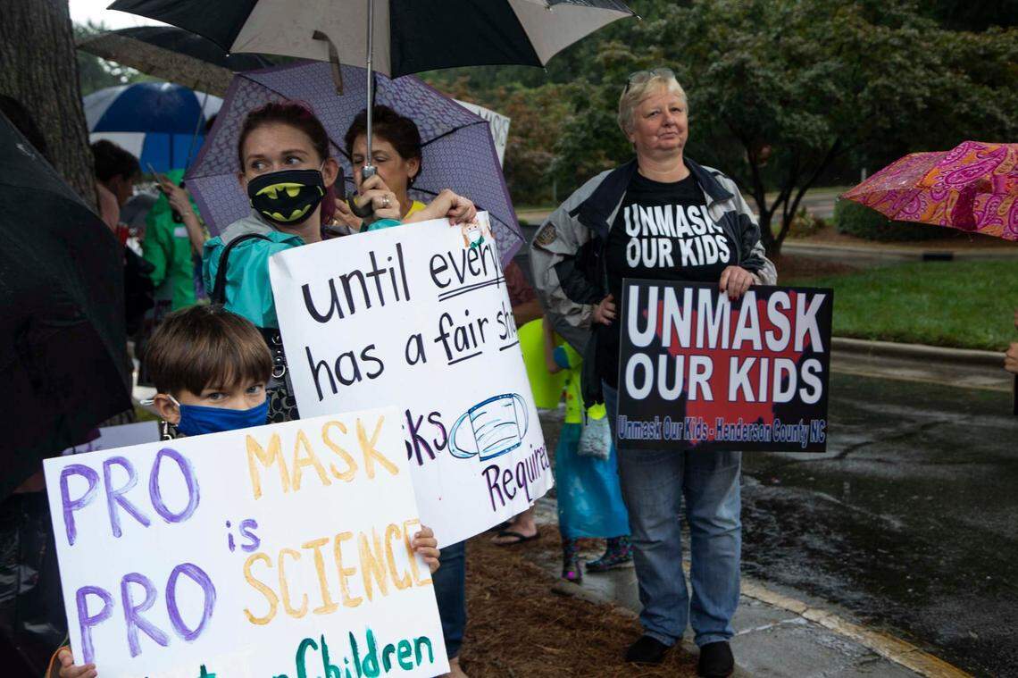 Protesters and counter-protesters demonstrate outside a Wake County Board of Education meeting Tuesday, Aug. 3, 2021 in Cary. The board will vote on a proposal to continue to require face masks in schools. Some parents argue the coverings should be optional.