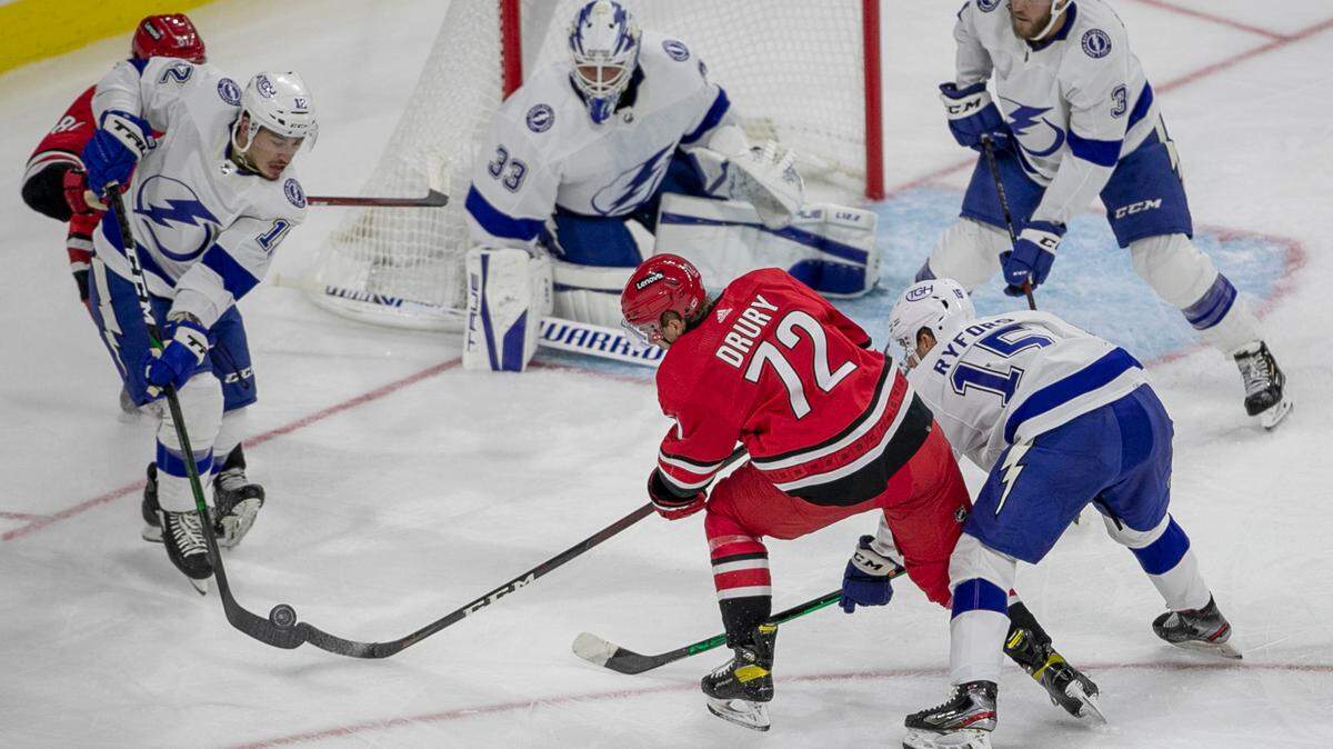 Tampa Bay’s Alex Barre-Boulet (12) and Simon Ryfors (15) defend Carolina Hurricanes’ Jack Drury (72) during the first period of their NHL exhibition game on Tuesday, September 28, 2021 at PNC Arena in Raleigh, N.C.