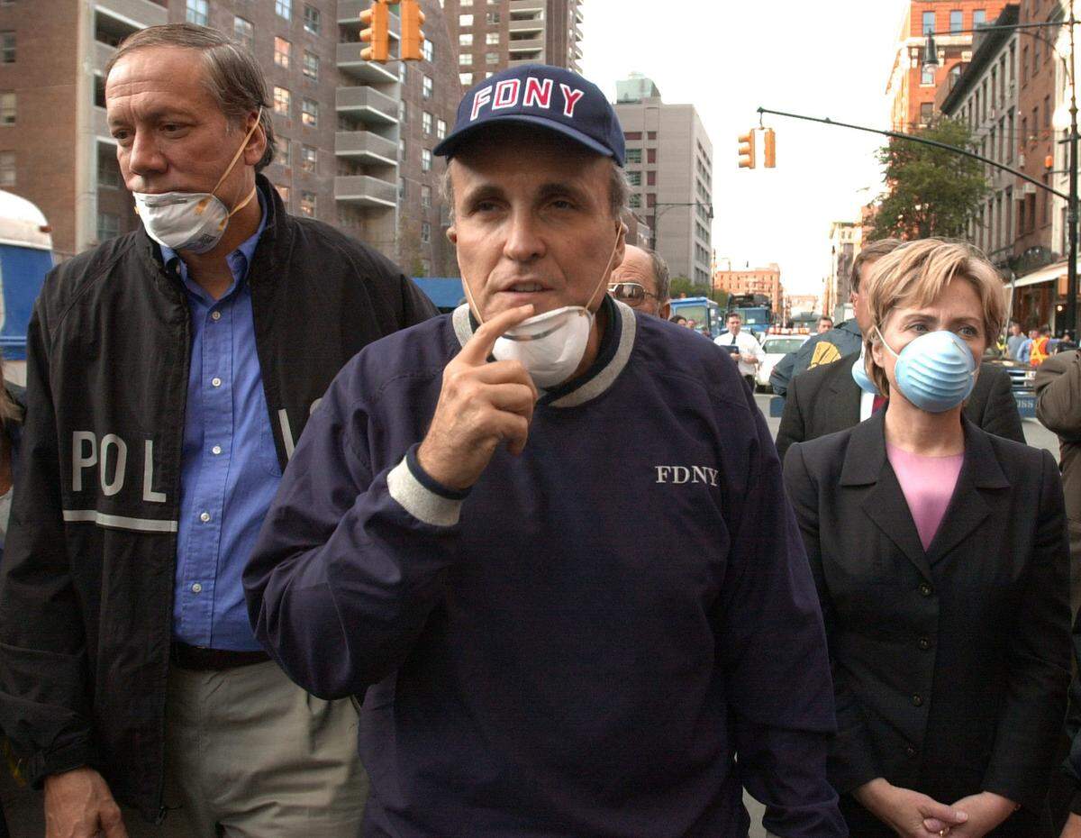 New York Mayor Rudy Giuliani, center, along with New York governor George Pataki and Senator Hillary Clinton arrive at the site of the World Trade Center towers.