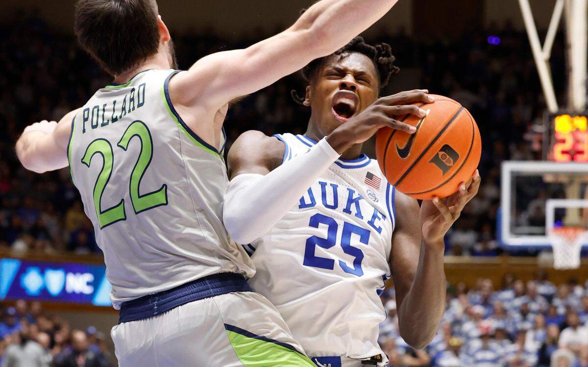 Duke’s Mark Mitchell (25) drives past Queens’ Jaxon Pollard (22) during the second half of Duke’s 106-69 victory over Queens University at Cameron Indoor Stadium in Durham, N.C., Saturday, Dec. 30, 2023.