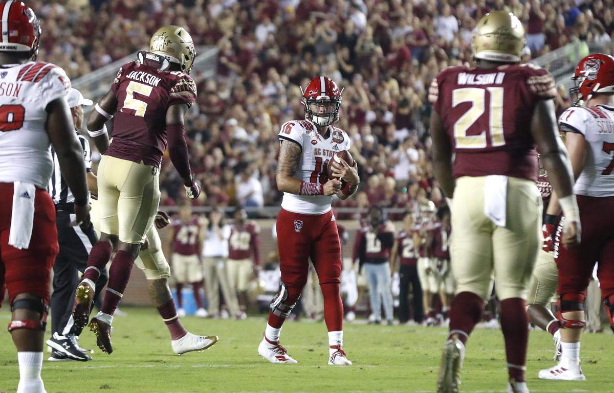 Florida State linebacker Dontavious Jackson (5) reacts after N.C. State quarterback Bailey Hockman (16) tripped on the foot of Grant Gibson while dropping back to lose five-yards on third and two during N.C. State’s game against Florida State at Doak Campbell Stadium in Tallahassee, Fla., Saturday, Sept. 28, 2019.
