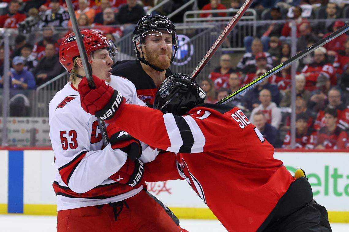 Apr 27, 2025; Newark, New Jersey, USA; New Jersey Devils defenseman Jonas Siegenthaler (71) hits Carolina Hurricanes right wing Jackson Blake (53) during the first period in game four of the first round of the 2025 Stanley Cup Playoffs at Prudential Center. Mandatory Credit: Ed Mulholland-Imagn Images