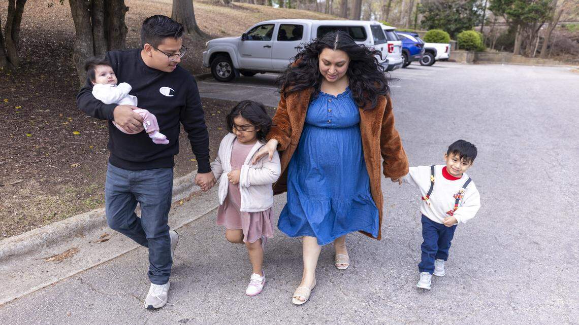 Moises Benitez Diaz, who came to the Triangle with his parents from Mexico when he was 5 years old, visits a Raleigh park with his wife, Esmeralda Escobar Vazquez, and their children, Elijah, 3, Rochelle, 5 and Eliana, 3-month-old, on Friday, March 13, 2026. Benitez Diaz was one of at least 370 people detained during a November 2025 immigration sweep that started in Charlotte and extended to the Triangle, dubbed “Operation Charlotte’s Web.” He was held at D. Ray James Correctional Facility in Folkston, Georgia, for three months and was released Feb. 27 on an $8,500 bond.