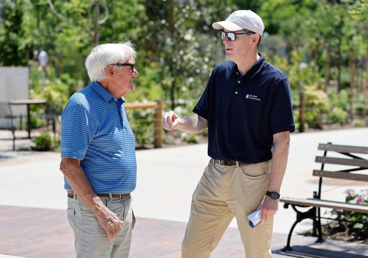 Ruffin Hall, CEO of the Dix Park Conservancy, right, talks with Tom Gipson at Gipson Play Plaza at Dix Park during a preview day Saturday, May 24, 2025.