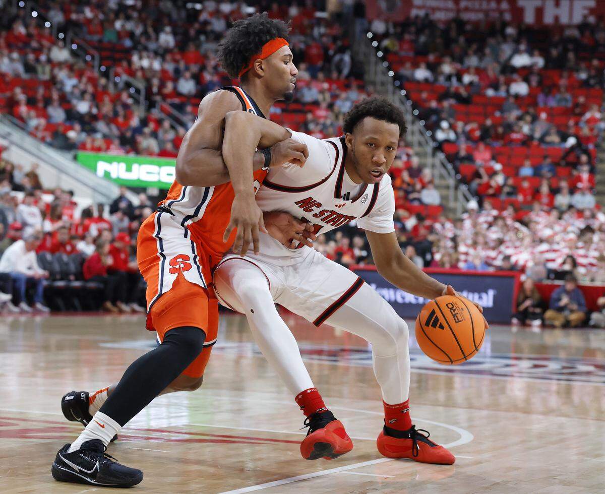 N.C. State’s Quadir Copeland dribbles around Syracuse’s J.J. Starling during the second half of the Wolfpack’s 88-68 win on Tuesday, Jan. 27, 2026, at Lenovo Center in Raleigh, N.C. 