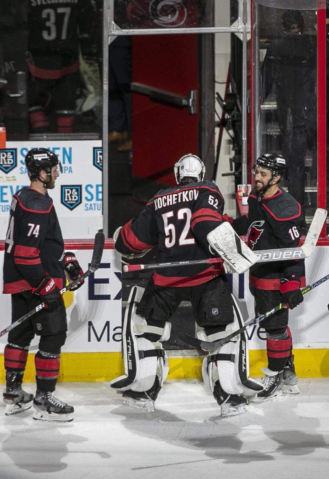 Carolina Hurricanes goalie Pyotr Kochetkov leaves the ice with teammates Jaccob Slavin (74) and Vincent Trocheck (16) following their 5-2 victory over Boston on Wednesday, May 4, 2022 during game two of their Stanley Cup first round series at PNC Arena in Raleigh, N.C.