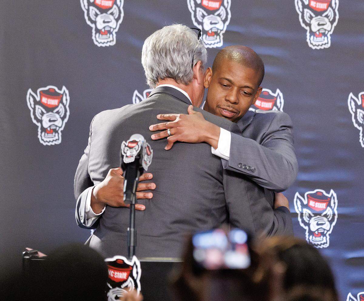 New N.C. State men’s basketball head coach Justin Gainey hugs Athletic Director Boo Corrigan after being introduced during a press conference at Lenovo Center on Wednesday, April 1, 2026, in Raleigh, N.C.