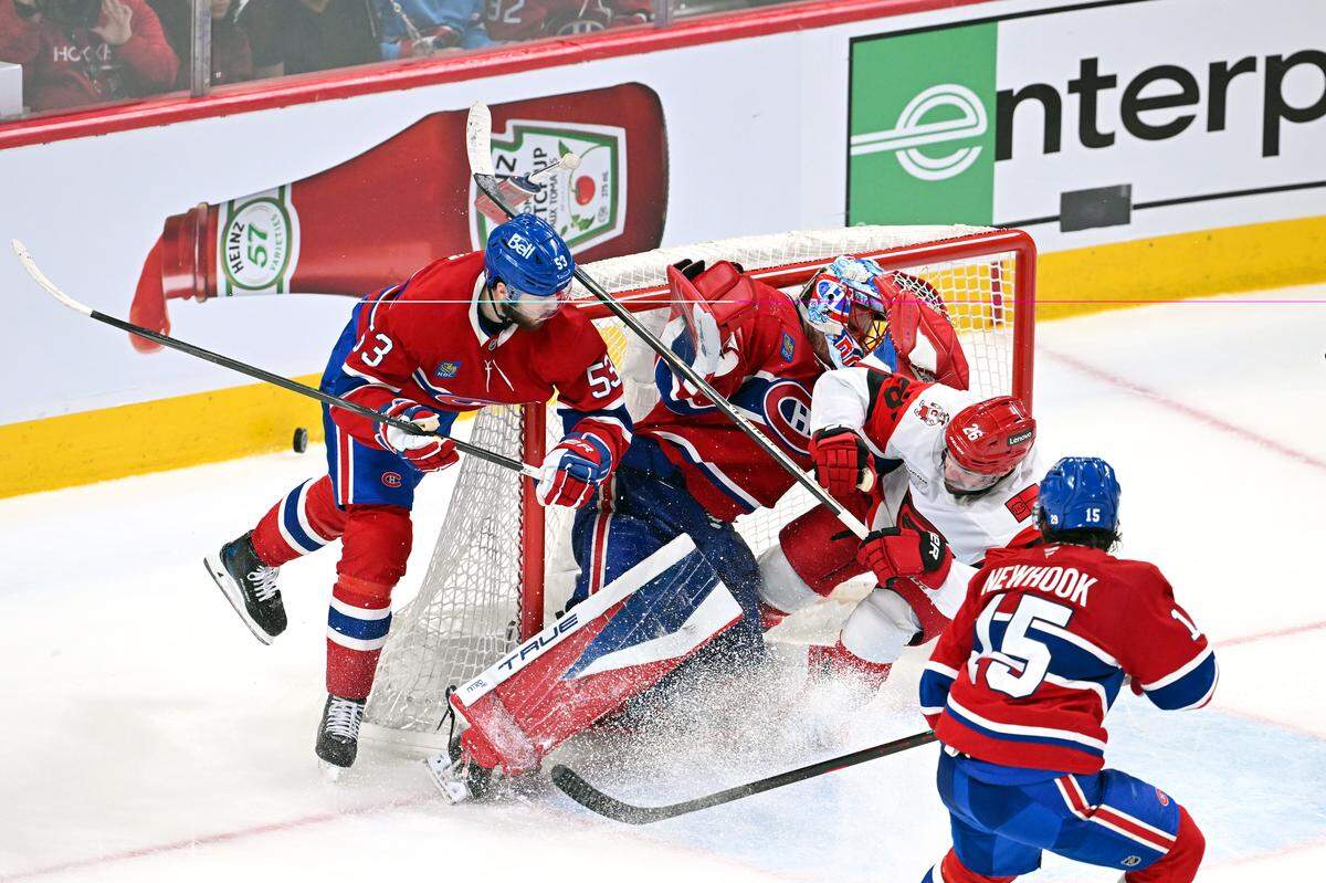 Sean Walker of the Carolina Hurricanes is called for goaltender interference against Jakub Dobes of the Montréal Canadiens as Noah Dobson (53) defends during the second period in Game 3 of the Eastern Conference Final of the 2026 Stanley Cup Playoffs at Bell Centre on May 25, 2026 in Montreal, Quebec, Canada.