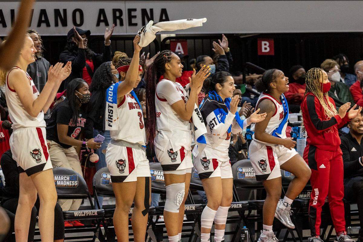 N.C. States bench celebrates against Longwood during the second half of the first round of the NCAA Championships Saturday, March. 19, 2022 at Reynolds Coliseum in Raleigh. N.C. State won 96-68.