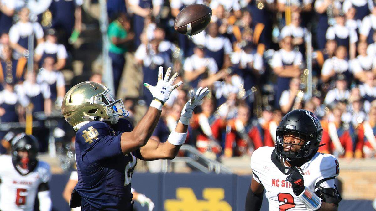 Will Pauling (2) of the Notre Dame Fighting Irish catches a passes while defended by Ronnie Royal III of the NC State Wolfpack in the first quarter at Notre Dame Stadium on October 11, 2025 in South Bend, Indiana.