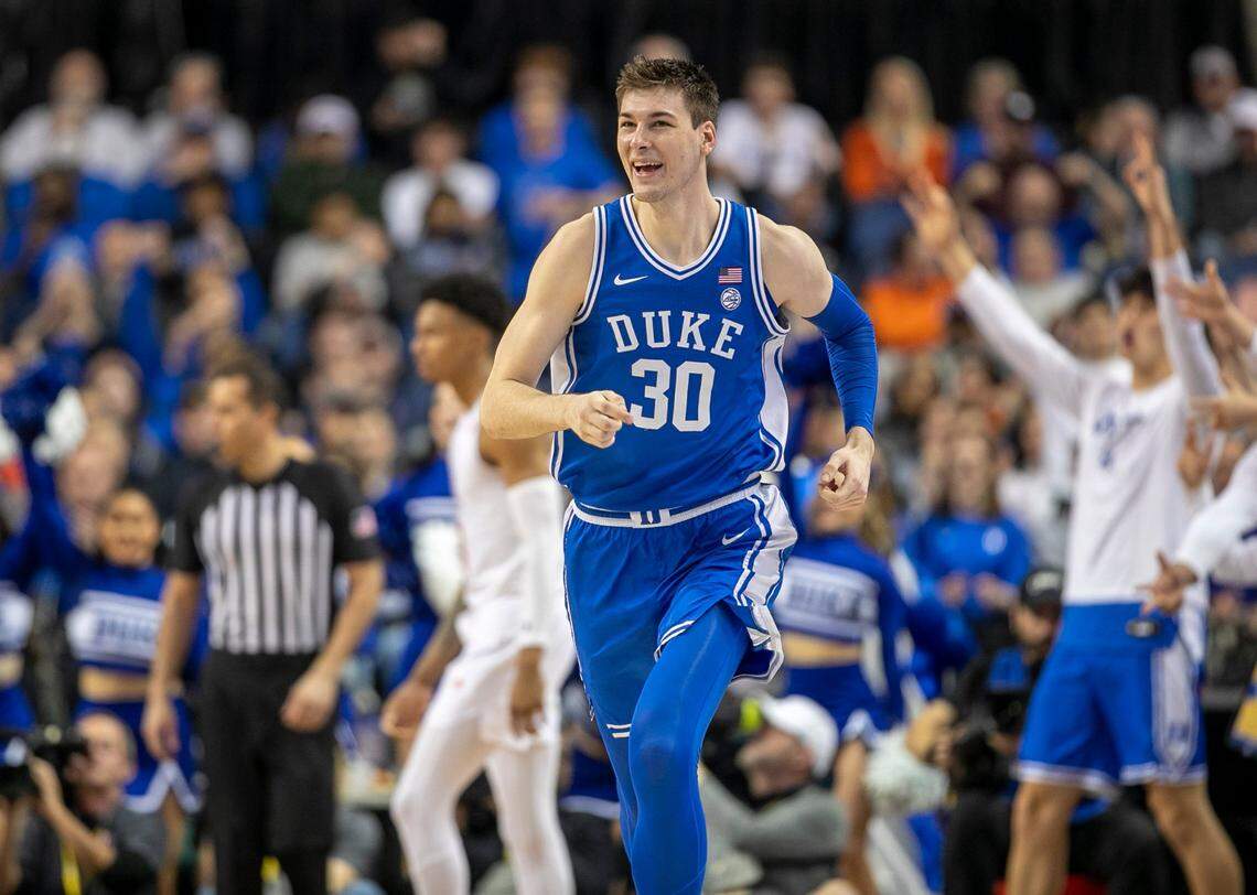 Duke’s Kyle Filipowski (30) reacts after sinking a there point basket to give the Blue Devils a 58-52 lead in the second half against Miami during in the semi-finals of the ACC Tournament on Friday, March 10, 2023 at the Greensboro Coliseum in Greensboro, N.C. Filipowski lead Duke with 17 points in their 85-78 victory.
