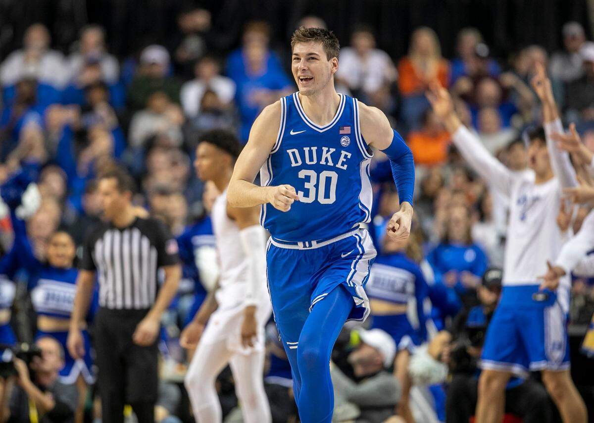 Duke’s Kyle Filipowski (30) reacts after sinking a there point basket to give the Blue Devils a 58-52 lead in the second half against Miami during in the semi-finals of the ACC Tournament on Friday, March 10, 2023 at the Greensboro Coliseum in Greensboro, N.C. Filipowski lead Duke with 17 points in their 85-78 victory.