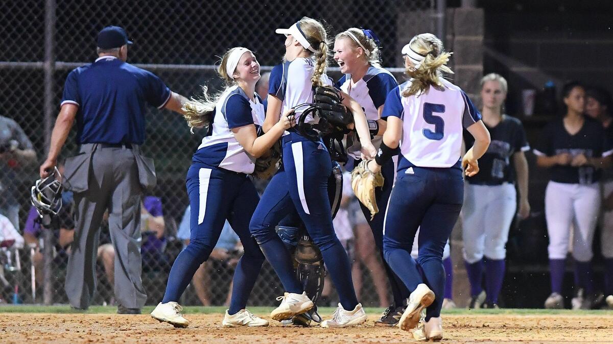 Heritage celebrate the win. The Holly Springs Golden Hawks visited the Heritage Huskies in a high school softball game on May 17, 2019. Heritage won 4-0.