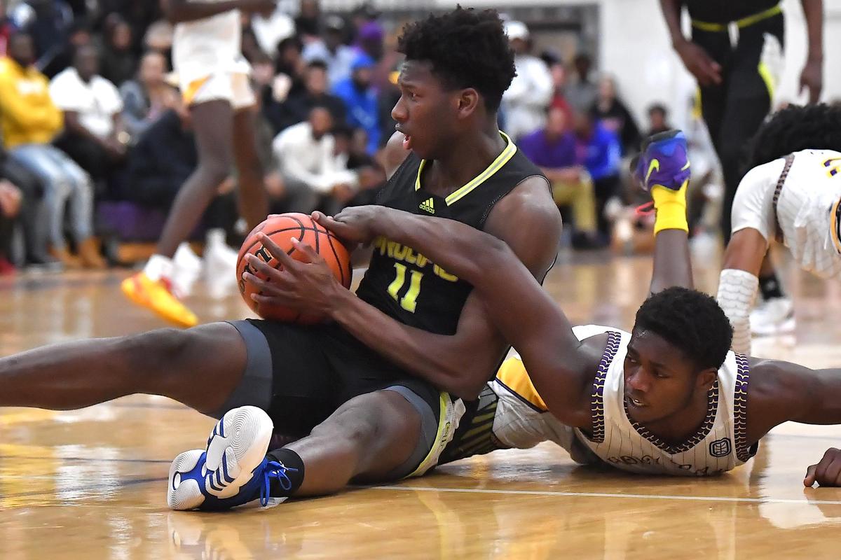 Word of God’s Jamal Brown (7) reaches in for the ball on Prolific Prep’s N’famara Debo (11) during the first half. and The Word of God Holy Rams and Prolific Prep (CA) met in the John Wall Holiday Invitational in Raleigh, N.C. on December 30,2022 .
