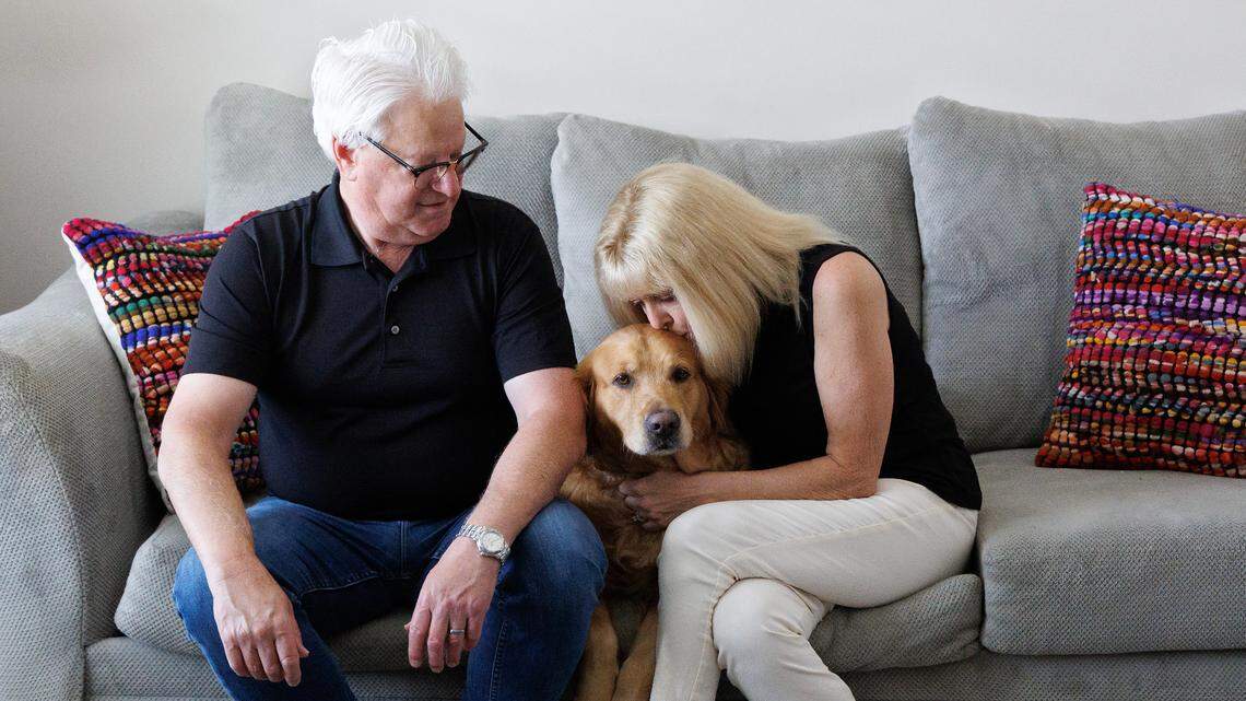 Chris and Terri Darden sit with their eight-year-old Golden Retriever, Roxy, at their new home in Raleigh, N.C.